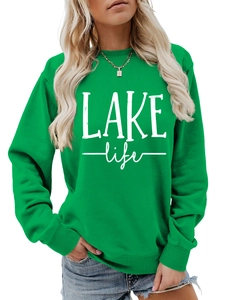 Close-up of Lake Life graphic lettering on a green crewneck sweatshirt with soft fabric