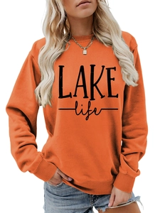 Detail of orange round neck sweatshirt with LAKE life letter print on ribbed cotton fabric