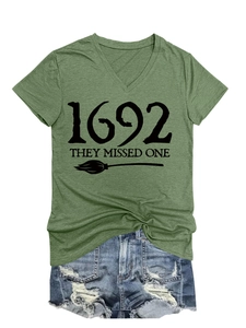 Close-up of green V-neck T-shirt with 1692 they missed one print and denim shorts