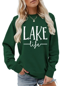 Detailed view of white LAKE life printed text on dark green crewneck sweatshirt