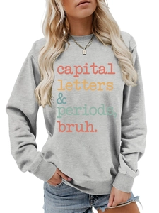 Detail of grey crewneck sweatshirt featuring colorful capital letters periods bruh print