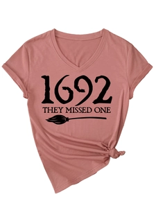 Detail view of V-neck dusty pink t-shirt with 1692 graphic and front hem tie detail