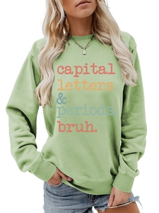 Detail of green crewneck sweatshirt featuring colorful capital letters periods bruh print