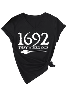 Close-up of V-neck cotton T-shirt with 1692 They Missed One witch broom print