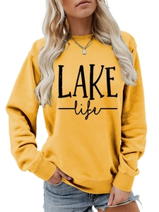 Close-up of LAKE life printed text on yellow crewneck sweatshirt soft cotton texture
