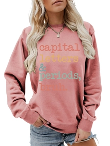 Detail of dusty rose sweatshirt featuring capital letters & periods bruh print design
