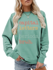 Detail of mint green sweatshirt with capital letters and periods bruh printed text