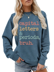 Close-up of blue sweatshirt featuring colorful capital letters periods bruh print design