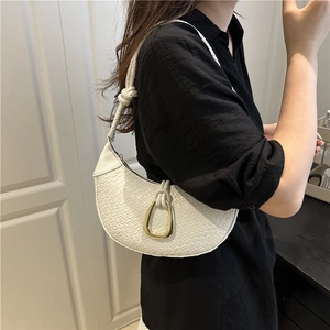 White woven crescent shoulder bag with gold buckle and stylish knotted strap detail