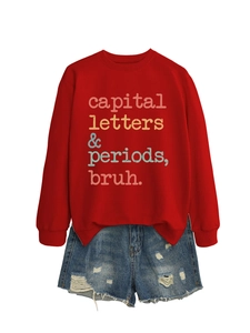 Detail of red crewneck sweatshirt with retro text print and distressed denim shorts