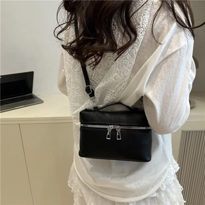 Elegant black lychee leather box bag with silver zippers and a slim shoulder strap