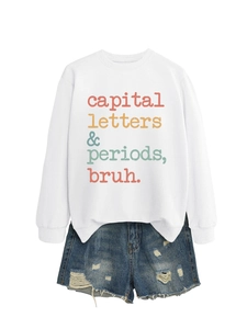 Flat lay of white slogan sweatshirt with blue distressed denim shorts set outfit