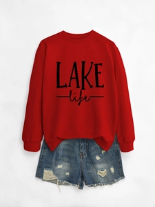 Detailed flat lay of red LAKE life sweatshirt paired with distressed denim shorts