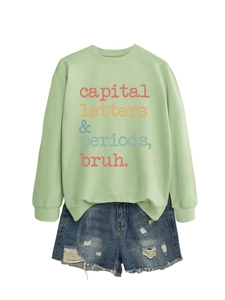 Flat lay of light green sweatshirt with retro capital letters periods bruh slogan print