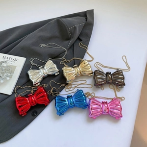 Metallic bow-shaped clutch purse with pleated texture and chain strap in various colors