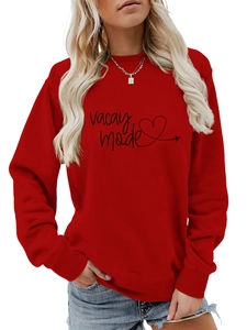 Detail view of Vacay Mode print and heart pattern on red long-sleeve sweatshirt