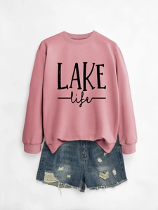 Detail of Lake Life print on pink sweatshirt paired with distressed denim shorts