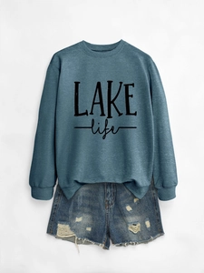 Detailed flat lay of long sleeve blue-grey sweatshirt featuring LAKE life lettering