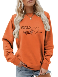 Detail of orange crewneck sweatshirt with Vacay Mode text and heart plane print