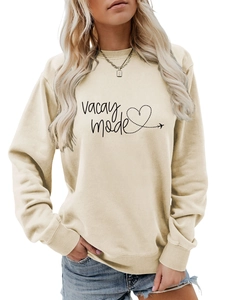 Close-up of Vacay Mode print and ribbed cuffs on beige long sleeve sweatshirt