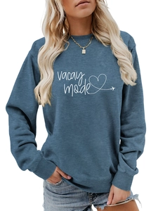Close-up of Vacay Mode print and heart airplane graphic on blue crewneck sweatshirt