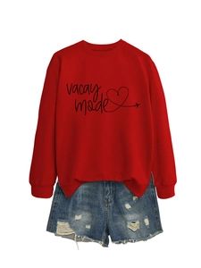 Detail of red crew neck sweatshirt with vacay mode print and distressed denim shorts