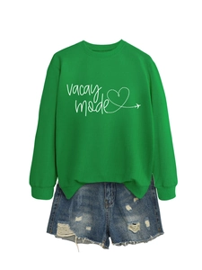 Flat lay of green 'vacay mode' sweatshirt with distressed denim shorts and heart print