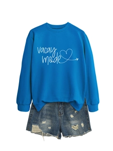 Detail of royal blue Vacay Mode sweatshirt with airplane heart and distressed denim shorts