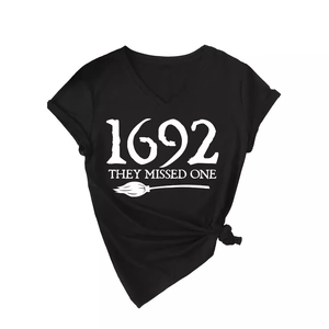 Black V-neck T-shirt featuring white 1692 They Missed One text and broom graphic print