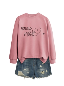 Detail of pink VACAY MODE sweatshirt with blue distressed denim shorts set