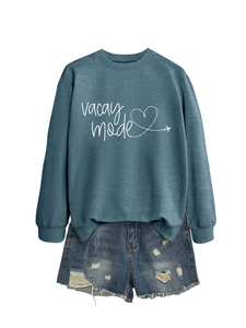 Detail view of blue-gray Vacay Mode sweatshirt paired with distressed denim shorts