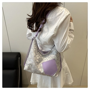 Detail of lavender geometric jacquard shoulder bag with purple pocket worn by model