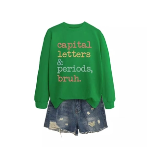 Women casual green sweatshirt with colorful text and distressed blue denim shorts