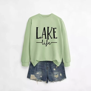 Casual light green LAKE life sweatshirt with distressed denim shorts for a relaxed look