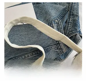 Macro shot of white corduroy texture and metallic zipper on minimalist shoulder bag