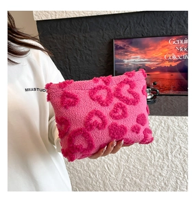 Dettaglio di borsa in peluche rosa rossa con trama in rilievo a forma di cuore strutturata