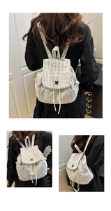 Detail view of stylish plaid backpack featuring drawstring closure and flap design