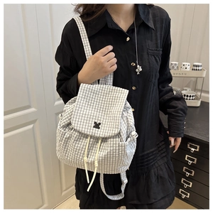 Fashionable black and white checkered backpack with drawstring closure and flap details