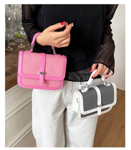 Detail shot of stylish canvas and leather patchwork handbags with elegant top handles