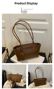 Detail view of coffee brown leather tote bag with side charm and long shoulder straps