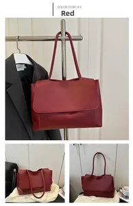Detail of the burgundy faux leather shoulder bag with wide flap and slim handles
