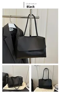Detail view of large black matte leather tote bag featuring a flap closure and minimalist style