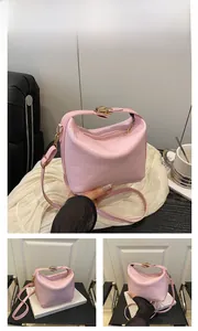 Detailed views of pink crocodile embossed leather handbag with gold metal hardware