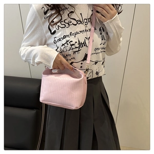 Pink leather shoulder bag for women featuring a minimalist rectangular design with adjustable strap