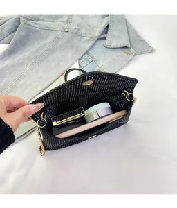 Detail view of the black envelope bag interior showing chain strap and ample storage space