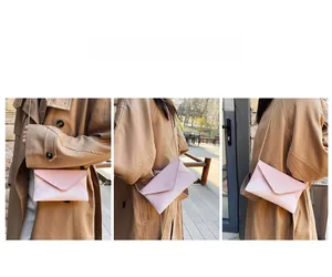 Three-way view of a pink envelope clutch with rhinestone texture and gold chain strap