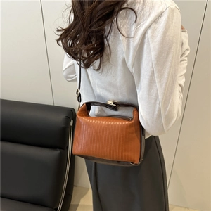 Pleated shoulder bag in caramel brown with adjustable strap and leather trim detail