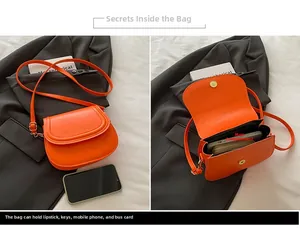 Detail view of orange saddle bag showing interior storage for phone and accessories