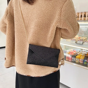 Chic black envelope crossbody bag with silver glitter dots and gold chain strap