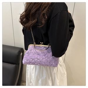Detail of purple 3D floral lace bag with gold chain strap and vintage metal clasp